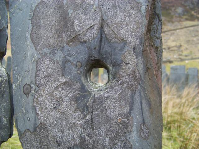 Bullet holes in slate enclosures