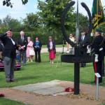 Patrick Higgins lays a cross to commemorate L/Cpl Eric Harden, VC., on behalf of Julie Wells