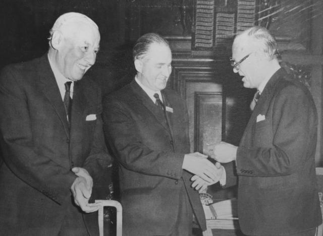 Henry Brown MBE being presented with a cheque by Major General Sir Robert Laycock KCMG, CB, DSO