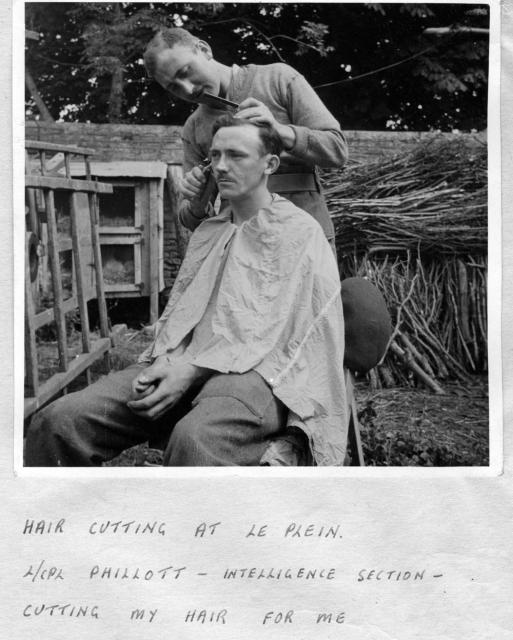 L/Cpl. Phillott cutting the hair of L/Cpl. 'Ken' Emmerson at le Plein