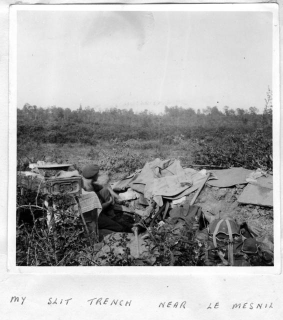 L/Cpl.  'Ken' Emmerson, No.1 SS Bde. HQ,  in a slit trench at Le Mesnil