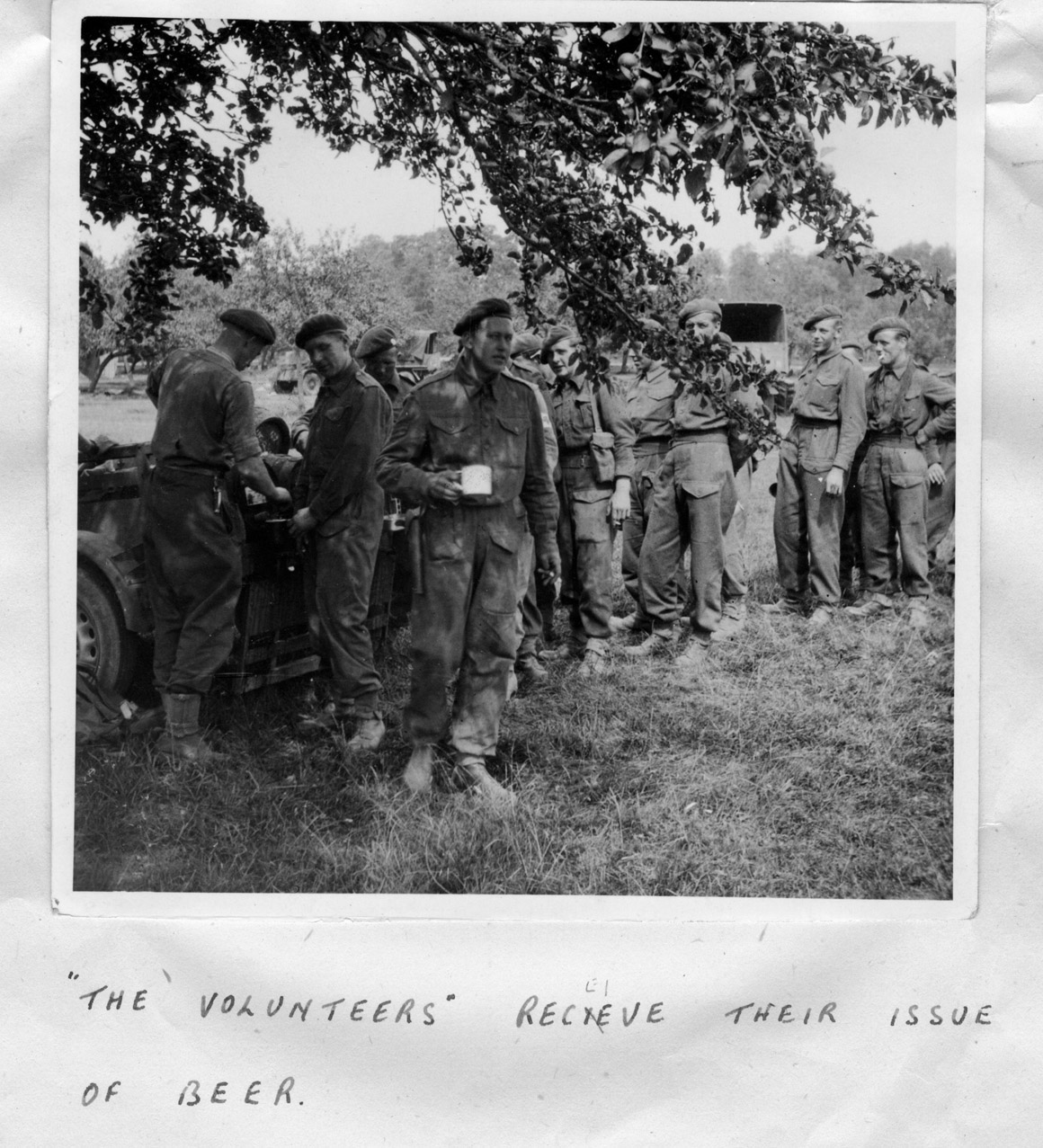 "Volunteers receive their issue of beer"  near Le Mesnil, August 1944