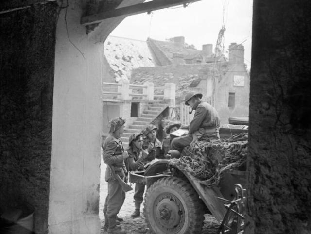 Captain J F Burgess, Royal Artillery, briefing a party of FOBs