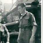 Terrence Kealy beside a military truck