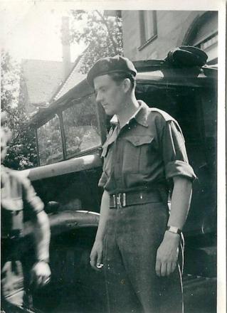 Terrence Kealy beside a military truck