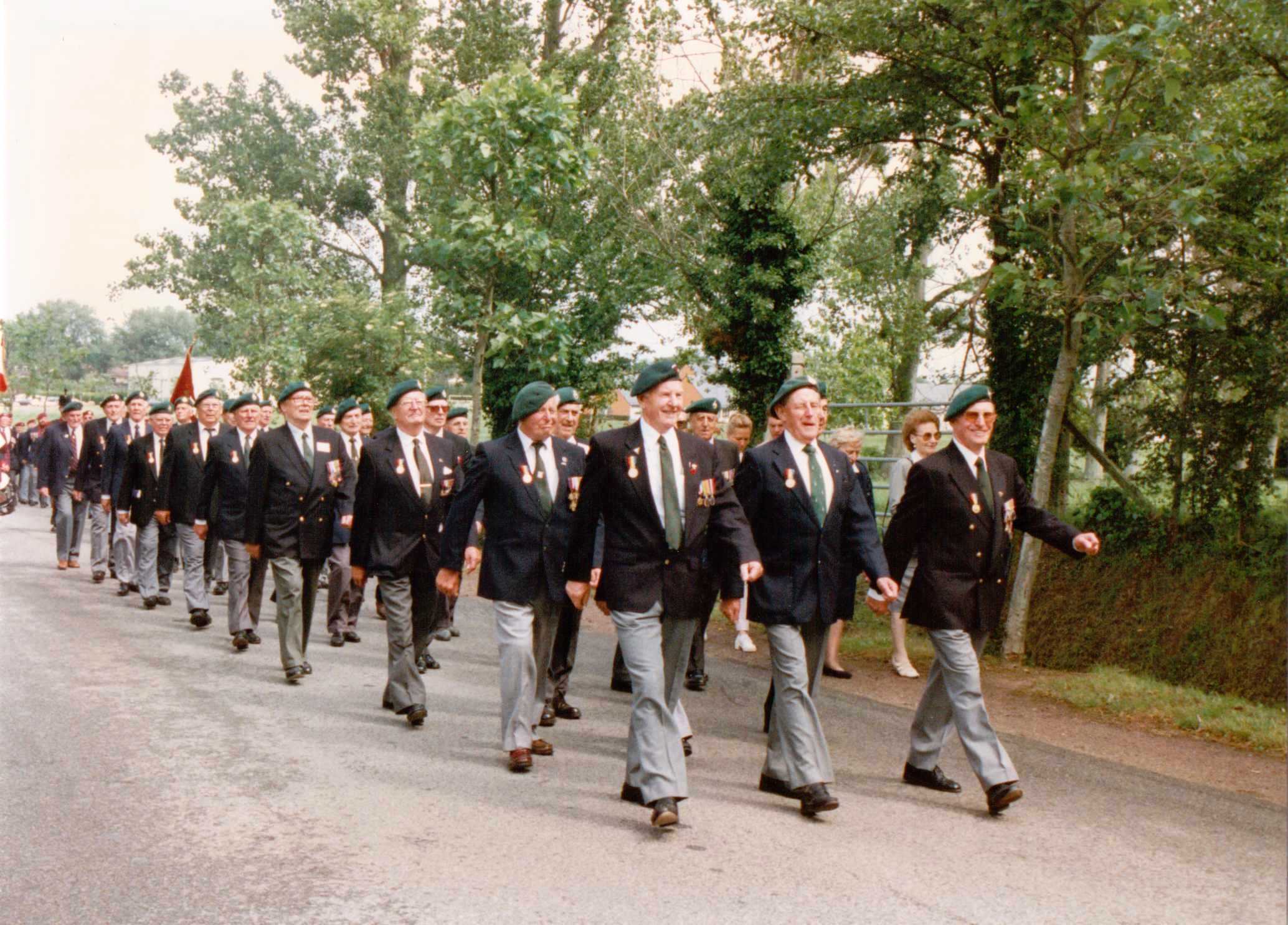 Veterans marching to Merville gun battery to lay wreaths at the bust of Lt. Col. Otway (Para) after the unveiling