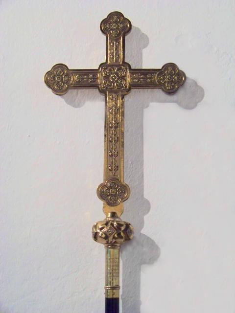 Close up of the detailed head of the Processional Cross  and inscription.