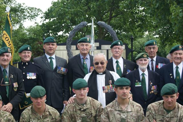 Green Berets past and present in front of the Army Commando Memorial