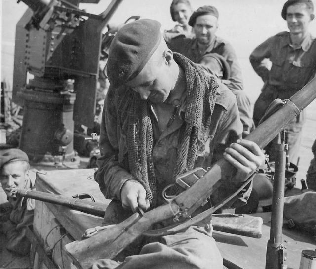 Marine Bill Nutt 44RM Cdo. carves another notch on his rifle butt, Mar'44 Burma