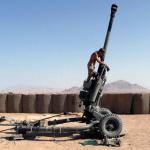 Gunner from 29Cdo cleaning a 105mm Light gun