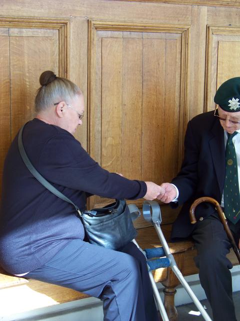 Sylvie Townshend taking money from Scotsman Jim Petrie, No.6 Commando.