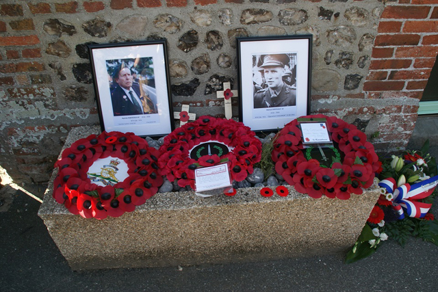 Wreaths and photos below the plaque to Pat Portoeus VC