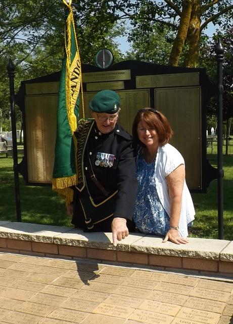 Fred Davies shows Anne George her father's paver