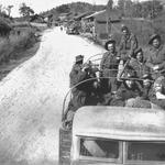 Fred Stock and Walter Marshall and others outside a village near Kumming.