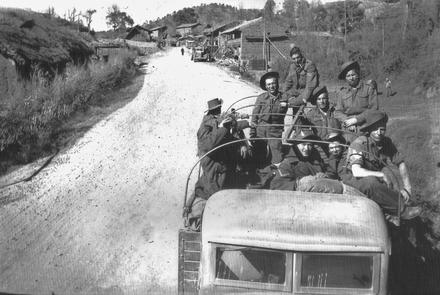 Fred Stock and Walter Marshall and others outside a village near Kumming.