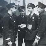 Frank Nightingale DCM shows his medal to his bus conductor colleagues