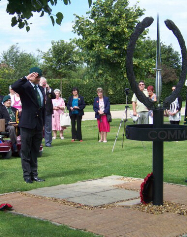 Geoff Murray salutes during the wreath-laying ceremony