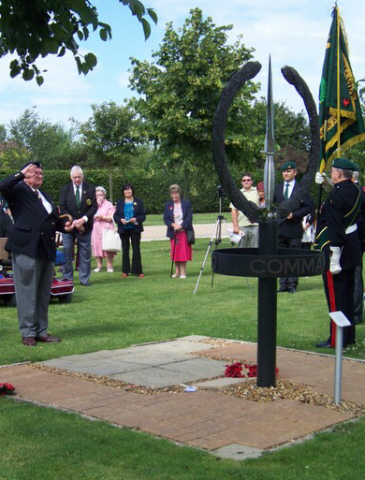 Patrick Higgins lays a cross to commemorate L/Cpl Eric Harden, VC., on behalf of Julie Wells