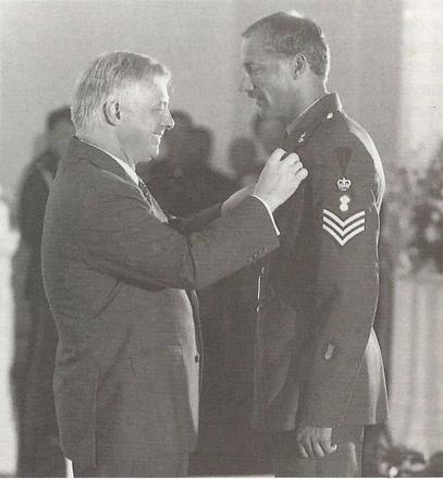 Sgt. Simon Wagstaff B.E.M. receiving his award from Chris Patton, Governor of Hong Kong.