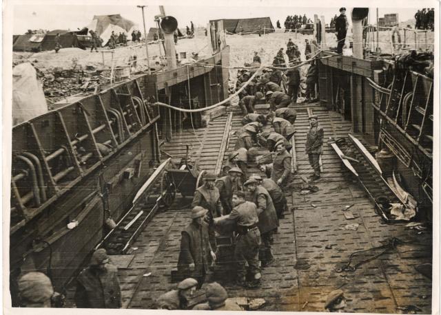 Commandos and Pioneer Corps, Beach Company, unload stores at Walcheren