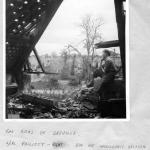 LCpl. Phillott , No.4 Cdo., and No.1  SS Bde. HQ Intelligence section amidst the ruins of Breville