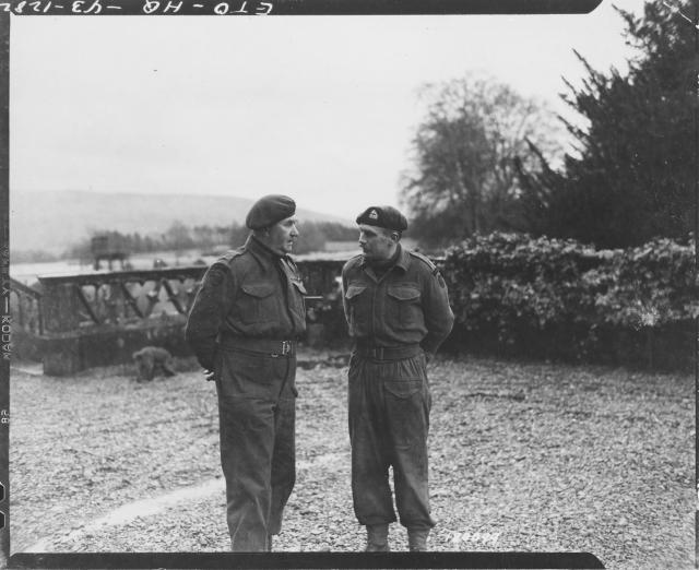 Lt. Col. C.E. Vaughan, Commandant, confers with his 2 i/c, Major Cockcraft, 12 Feb. 1943
