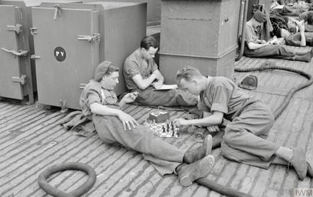 No.4 Cdos.,LBdr. Spencer plays chess with Pte. Gulvin. LCpl Preece reads book. June 1944