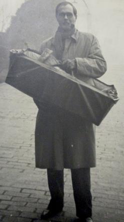 Roger Hilton (No.3 Cdo) carrying his son Matthew in the cot.