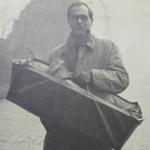 Roger Hilton (No.3 Cdo) carrying his son Matthew in the cot.