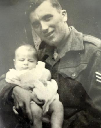 Sgt. Wilfred Joseph Broderick, 45RM Commando, and child