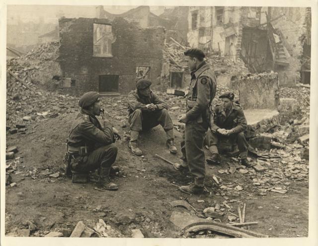 Brian Butler MC (left), Captain Gordon Pollard MC MM, Lt. Harry Williams (standing), John Alderson MC (right)