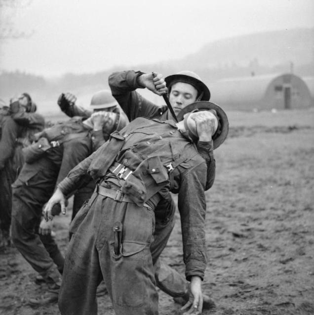 Commandos use fighting knives during close-quarter combat practice in Scotland, 9 Jan. 1943.
