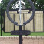 The CVA Memorial with the central stand of the Army Commando Memorial Wall behind.