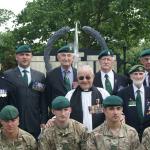 Green Berets past and present in front of the Army Commando Memorial
