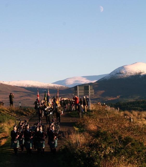 Lochaber High School Pipers lead the march to the Memorial at Spean Bridge