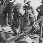Marine Bill Nutt 44RM Cdo. carves another notch on his rifle butt, Mar'44 Burma