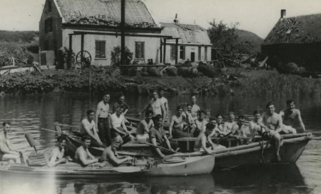 Thomas McGuinness and others in boats