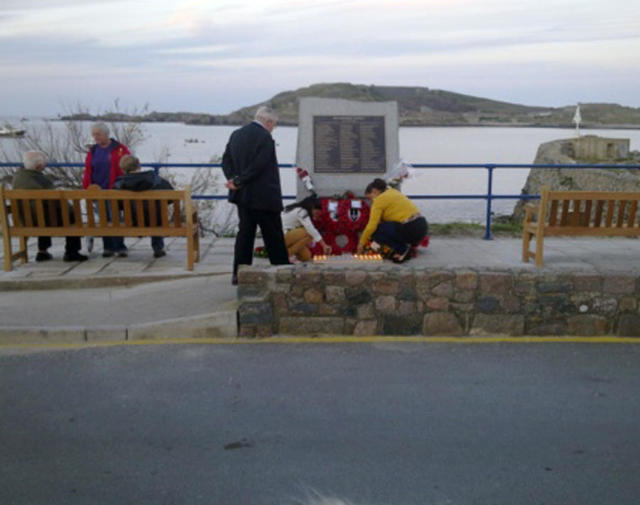 Lighting candles in memory of the lost on HMS Affray