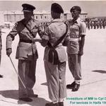 Corporal Dennis Earp, 40 Cdo. RM, receiving his MM, from the Brigadier in Malta 1958