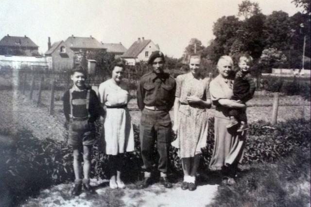 Roy Suzuki No 6 Cdo with a German family after liberating the village