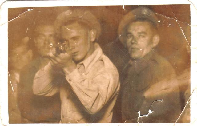 Alf Sawyer aiming the rifle and others