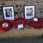 Wreaths and photos below the plaque to Pat Portoeus VC