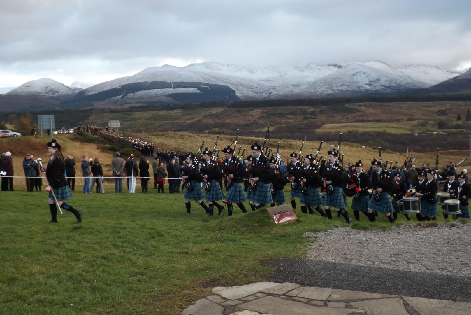 The Pipe Band leads the procession to The Monument.