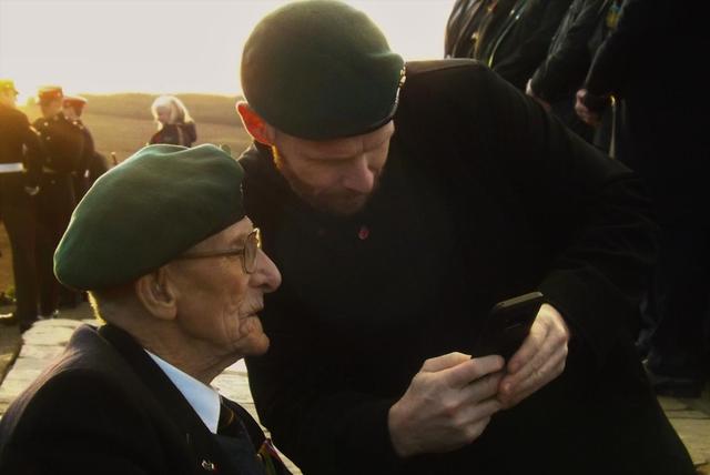 Mark showing Ted some photos...