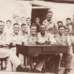 Sgt 'Chalky' White, No.2 Commando (on the right with stick) and others
