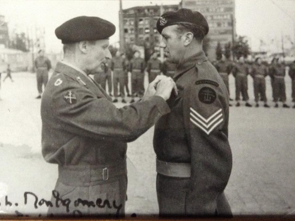 Sgt. Cyril Dobb, No.6 Cdo., receiving his MM from Montgomery