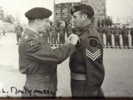 Sgt. Cyril Dobb, No.6 Cdo., receiving his MM from Montgomery