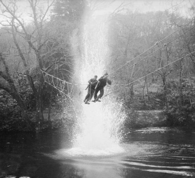 Commandos cross a river on a 'toggle bridge'