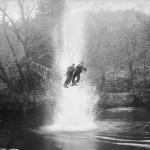 Commandos at Achnacarry cross a river on a 'toggle bridge'