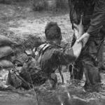 Gnr. L. Stewart being assisted out of the water tunnel by Lt Dalton, July 1964